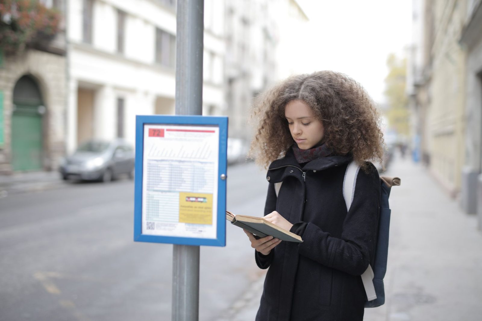 Woman waiting at a bus stop